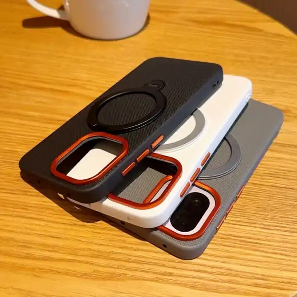 Dark ribbed iPhone case with copper camera bezel and MagSafe compatibility on a white background